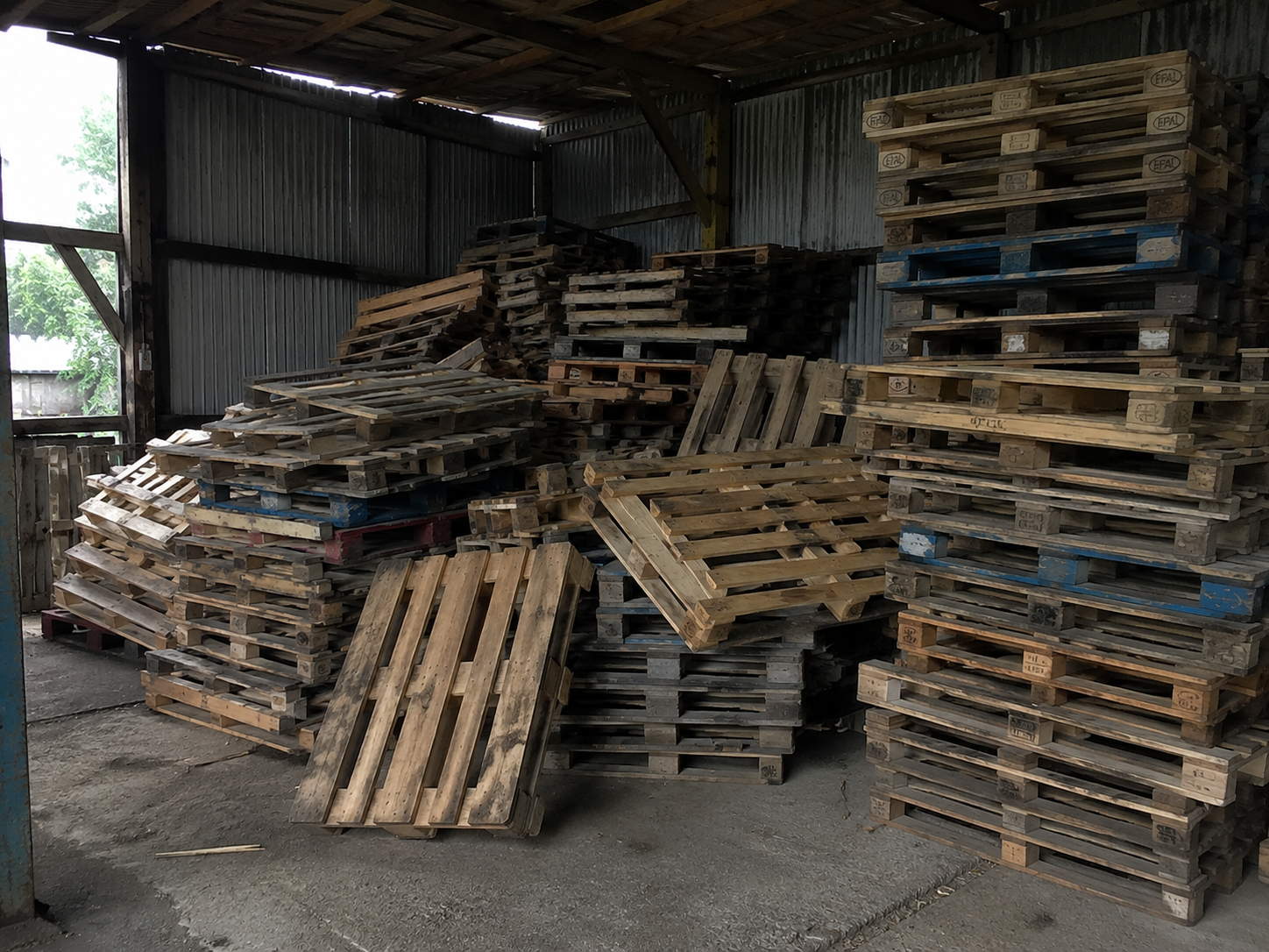 A large pile of reclaimed pallets awaiting triage and sorting